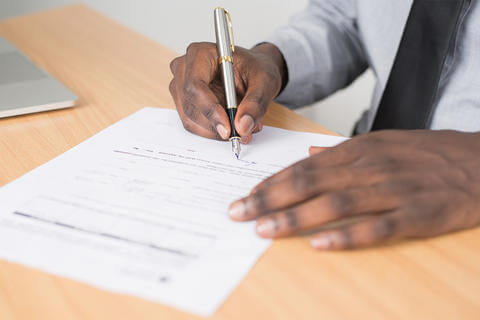 Image of hands writing with pen and paper